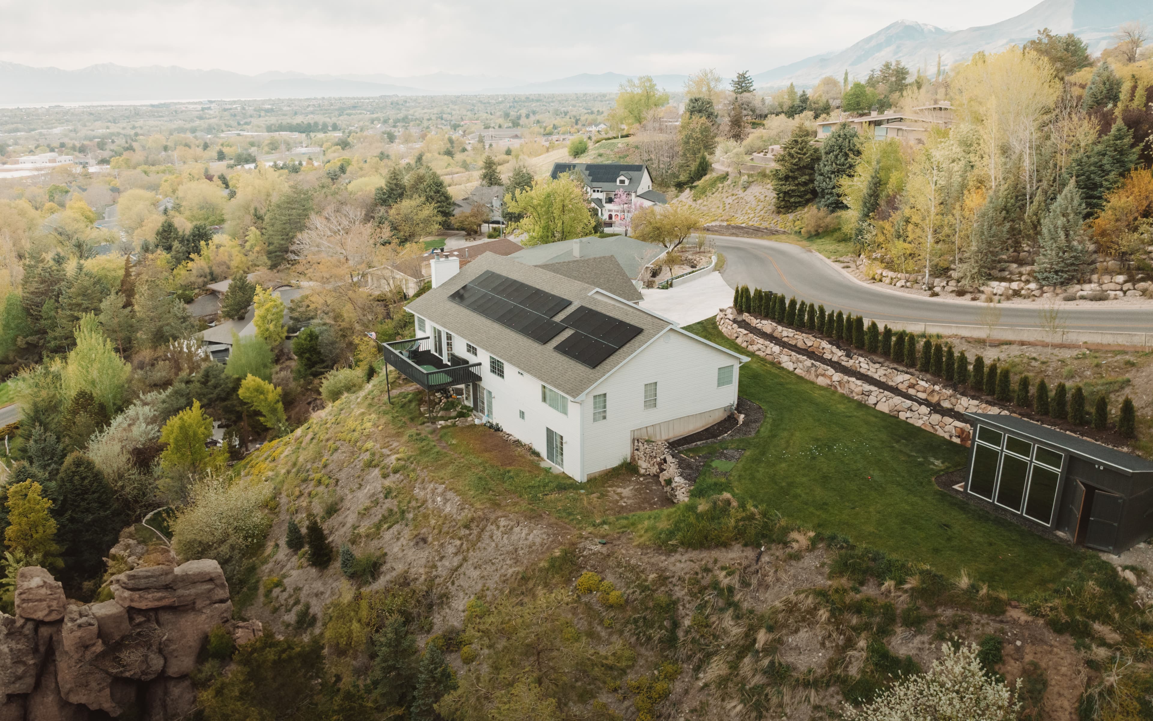 Aerial view of a solar-powered home on a hillside