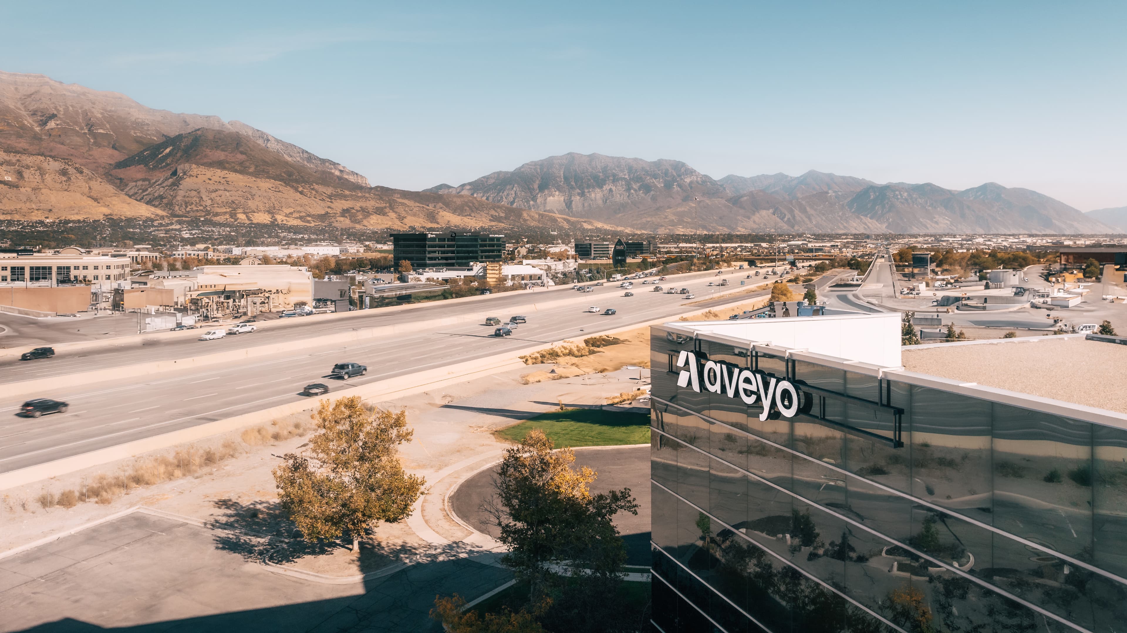 Aveyo office building with Wasatch mountains in background, clear day